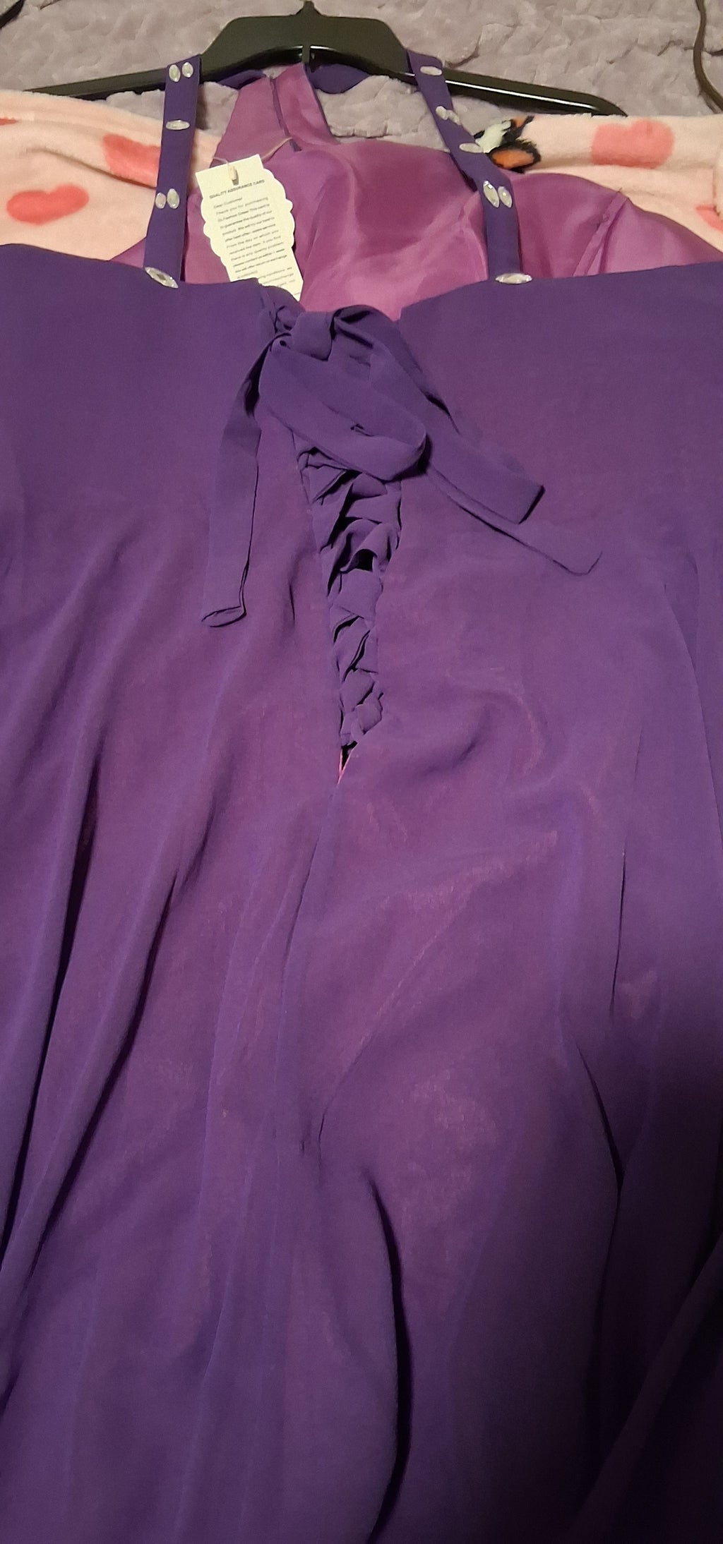 Purple top with lace-up front on a hanger
